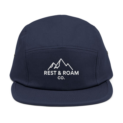 Close-up of a Navy embroidered 5-panel camp hat with Rest & Roam Co. mountain logo on front panel