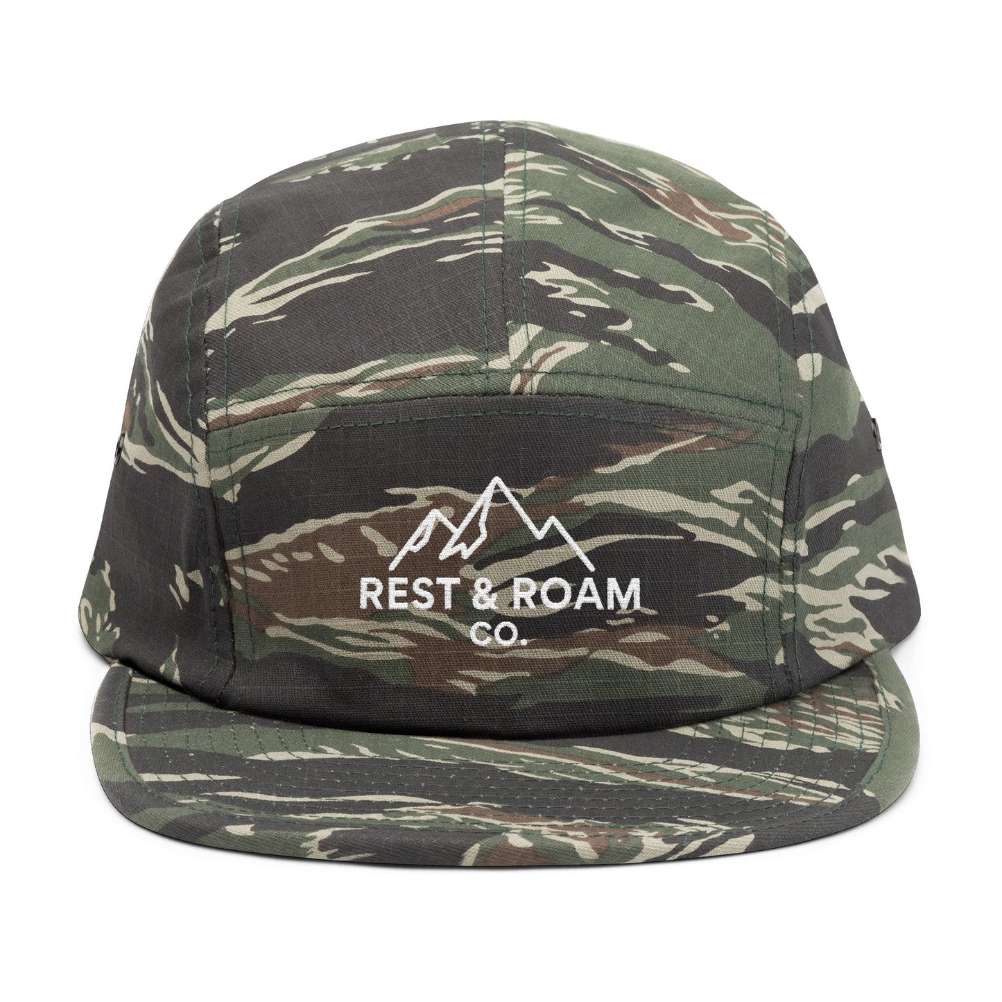 Close-up of an camo embroidered 5-panel camp hat with Rest & Roam Co. mountain logo on front panel