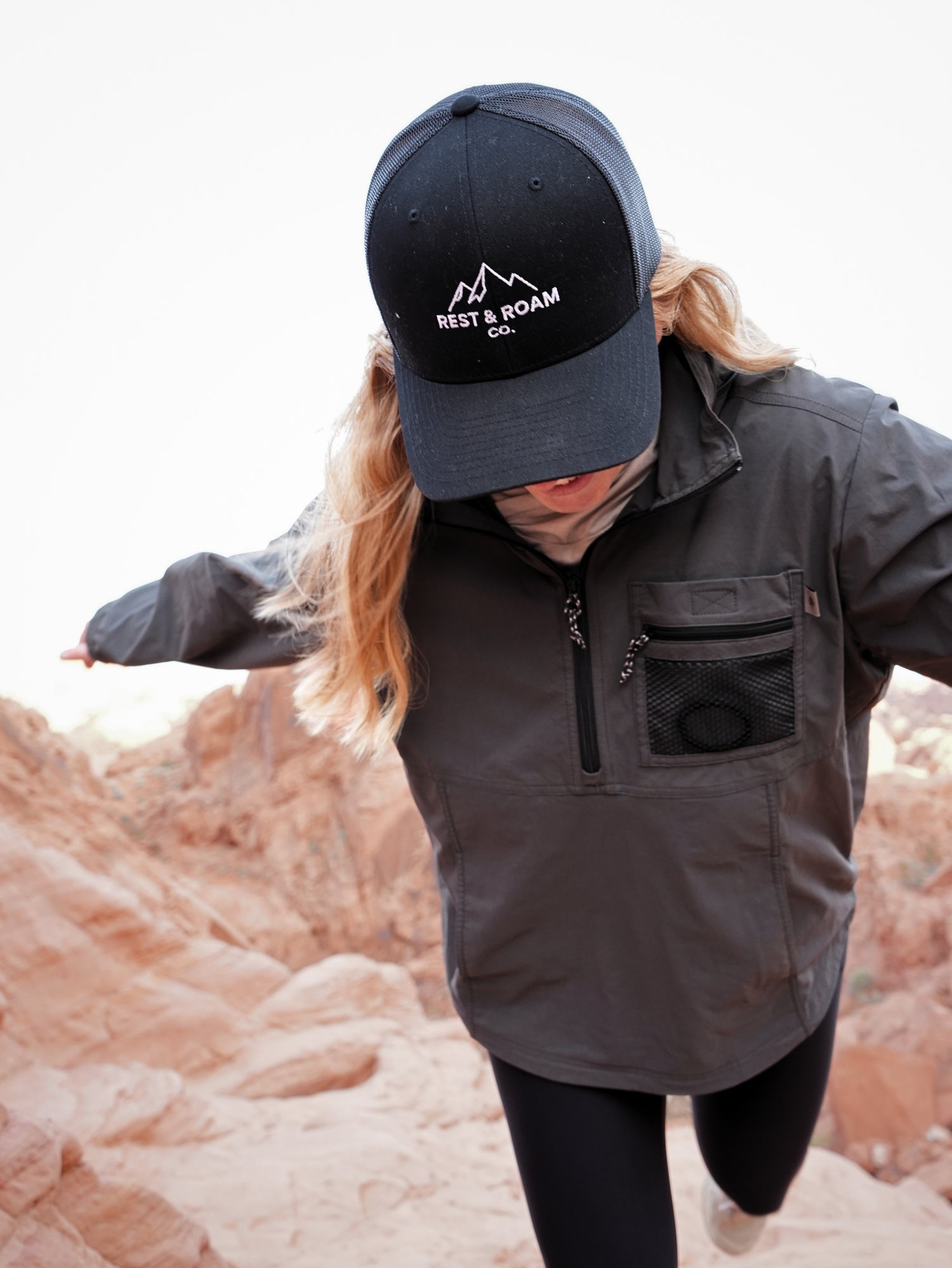 Woman wearing trucker cap enjoying nature in Valley of Fire with a black wind jacket